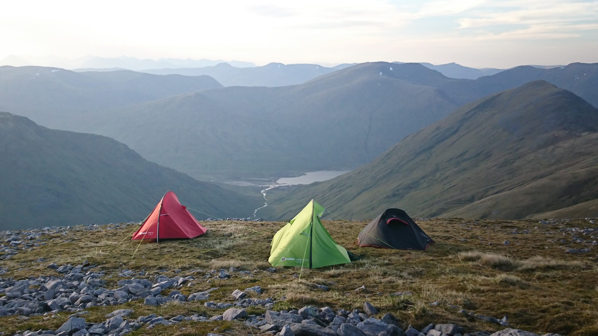 Wild camping on a Scottish mountain summit at sunset